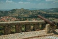 Cannon overlooking hilly landscape in Monsanto