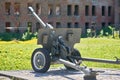 Cannon Second World War against the background of a destroyed red brick building