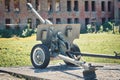cannon Second World War against the background of a destroyed red brick building Royalty Free Stock Photo