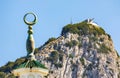 A cannon on the summit of Gibraltar with a mosque in the foreground. Royalty Free Stock Photo