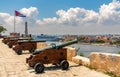 Cannons at Fort of Saint Charles, cuban flag and cruise ship in Havana Royalty Free Stock Photo