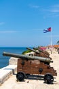 Cannons at Fort of Saint Charles, cuban flag in Havana Royalty Free Stock Photo