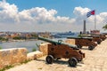 Cannons at Fort of Saint Charles, cuban flag and cruise ship in Havana Royalty Free Stock Photo