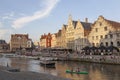 Canoe and boats in river Leie in medieval centre in belgian town