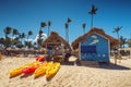 Canoe Kayak boats on sunny tropical beach with palm trees Royalty Free Stock Photo