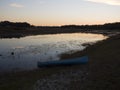 Canoe By the Lake At Sunset Royalty Free Stock Photo