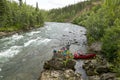 Canoe launching beside wild Alaskan river rapids Royalty Free Stock Photo