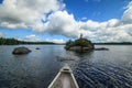 Canoe and light house on Canadian lake. Royalty Free Stock Photo