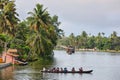 Canoe with little students crossing the backwaters in the backwaters of Allepey, Kerala, India