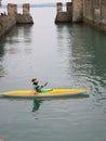 Canoe with oarsman in the middle of the creek of Desenzano