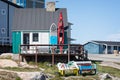 Canoe and paddle board on veranda of colourful wooden house in Ilulissat, Greenland