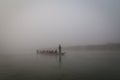 Canoe on river in morning mist, Chitwan National Park, Nepal Royalty Free Stock Photo