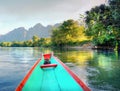 Canoe on a river surrounded with amazing mountains