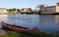 Canoe seating on the grass by the water, Mystic River Bascule Bridge in the background, Mystic, CT