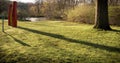 Canoe seats facing the huron river and casting shadows in the grass