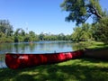 Canoe on shore on Toronto Islands with city skyline behind