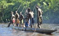 Canoe war ceremony of Asmat people. Headhunter of a tribe of Asmat in a mask with an o Royalty Free Stock Photo