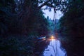 Canoeing in a dark rainforest
