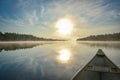 Canoeing on a misty summer morning on Corry Lake. Royalty Free Stock Photo