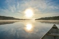 Canoeing on a misty summer morning on Corry Lake. Royalty Free Stock Photo