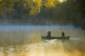 Canoeing through morning mist Royalty Free Stock Photo
