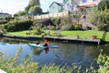 A canoeist paddles along the canal at Sampford Peverell on the Grand Western canal in Devon