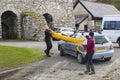 Canoeists unloading a canoe from a car roof rack in Ballintoy Northern Ireland Royalty Free Stock Photo