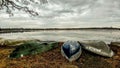 Canoes Along Lakeshore on Cloudy Day