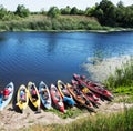 Canoes on a river-bank.