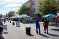 Customers mill about the farmer and jewelry stands at the Canoga Park Farmer`s Market on Owensmouth Ave.