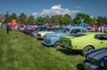 People Enjoying a Beautiful Summer Day Viewing Vintage Cars