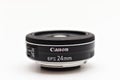 Canon EF-S 24 mm STM lens for digital SLR crop cameras with the logo facing forward. Close up studio photo in soft light