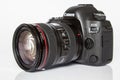Canon EOS 5D Mark IV profesional DSLR photo camera on white reflective background Royalty Free Stock Photo