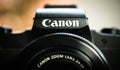 Canon G1X compact camera front view detail focus on logo name high level photography equipment