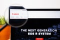 Canon Logo under a magnifying glass on Canon Website on a Laptop screen
