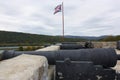 Canons along outer wall of Fort Ticonderoga in Ticonderoga, New York, in the fall with mountains and lake in the background