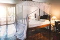 Canopy bed in tropical resort bedroom Royalty Free Stock Photo