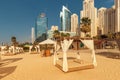 canopy with curtains and sunbeds waiting for tourists in Dubai Jumeirah beach resort. Luxury vacation concept Royalty Free Stock Photo