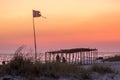 Canopy and flag on a wild beach