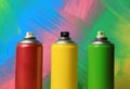 Cans of different spray paints on color background, closeup. Graffiti supplies Royalty Free Stock Photo