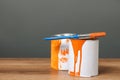 Cans of orange paint and brush on wooden table. Space for text Royalty Free Stock Photo