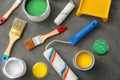 Cans of paint, roller and brushes on grey background Royalty Free Stock Photo