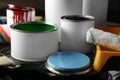 Cans of paint and roller on table Royalty Free Stock Photo