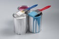 Cans of paints and brushes on light blue background Royalty Free Stock Photo