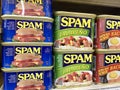 Cans of Spam lunchmeat on a store shelf