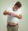 Cant get enough marshmallows. an overweight man with marshmallows shoved in his mouth.