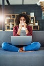 Cant get to the doctor Try an online consultation. a young woman blowing her nose while using a laptop on the sofa at Royalty Free Stock Photo