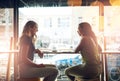 We cant think of a better way to begin Friyay. two young women at a cafe.