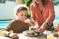 He cant wait to dig in. a mother dishing up food for her little boy at Christmas lunch party.