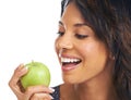 She cant wait to take that first bite. A pretty young woman biting into a crunchy apple. Royalty Free Stock Photo